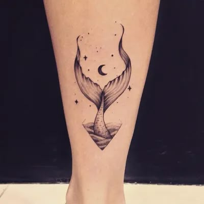 a woman's foot with a small tattoo on the side of her leg and an image of a whale tail