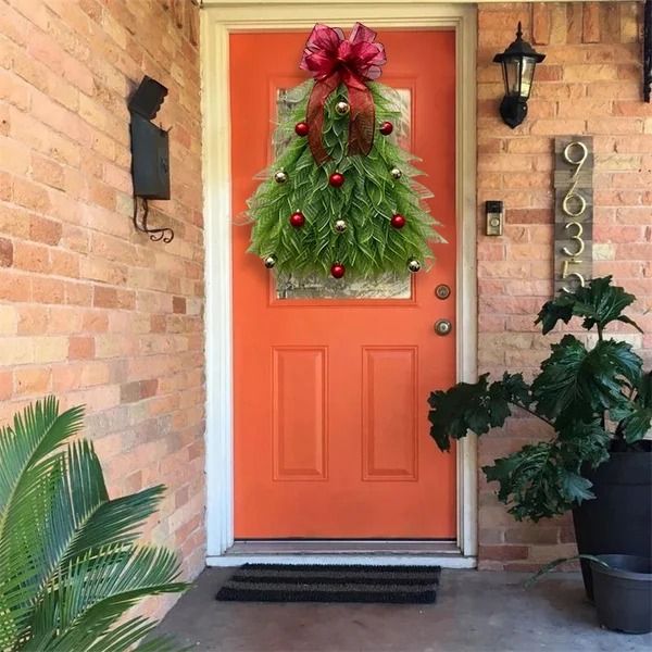 a red front door with a wreath on it