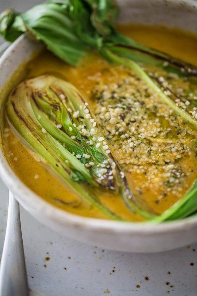 a white bowl filled with soup and vegetables