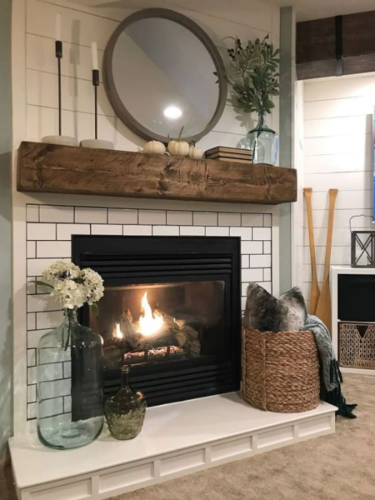 a fireplace with a mirror above it