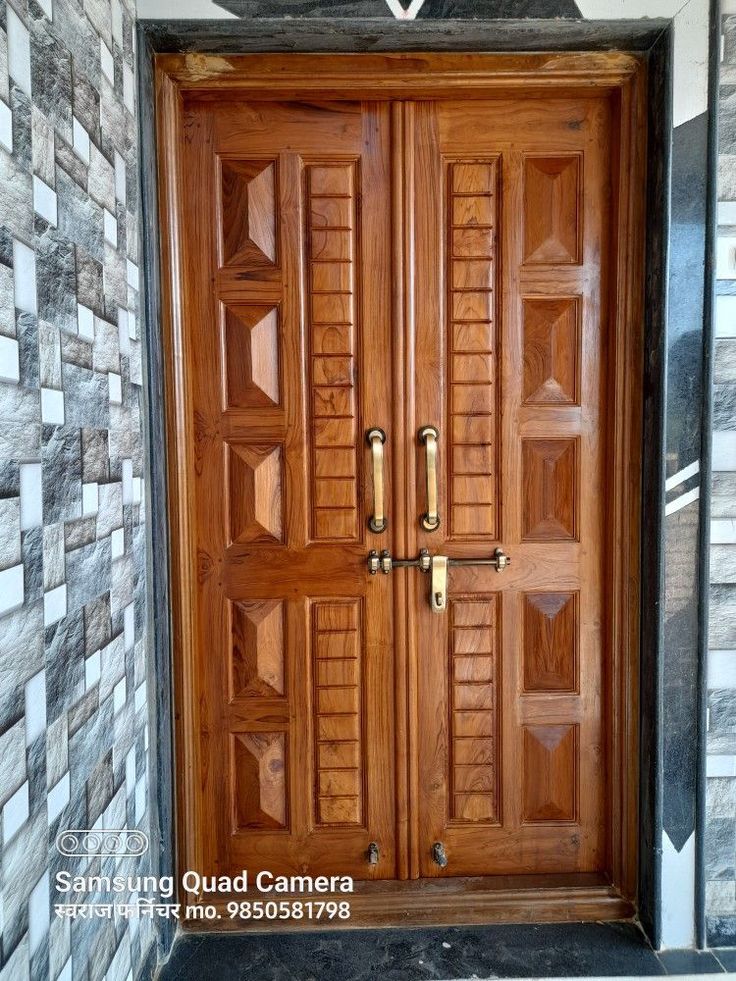 a wooden door is open in front of a wall with decorative tiles on the walls