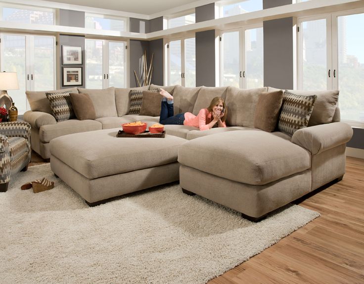 a woman laying on top of a couch in a living room