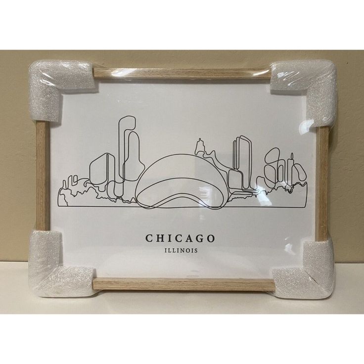 a chicago skyline drawn in black and white on a clear acrylic glass frame