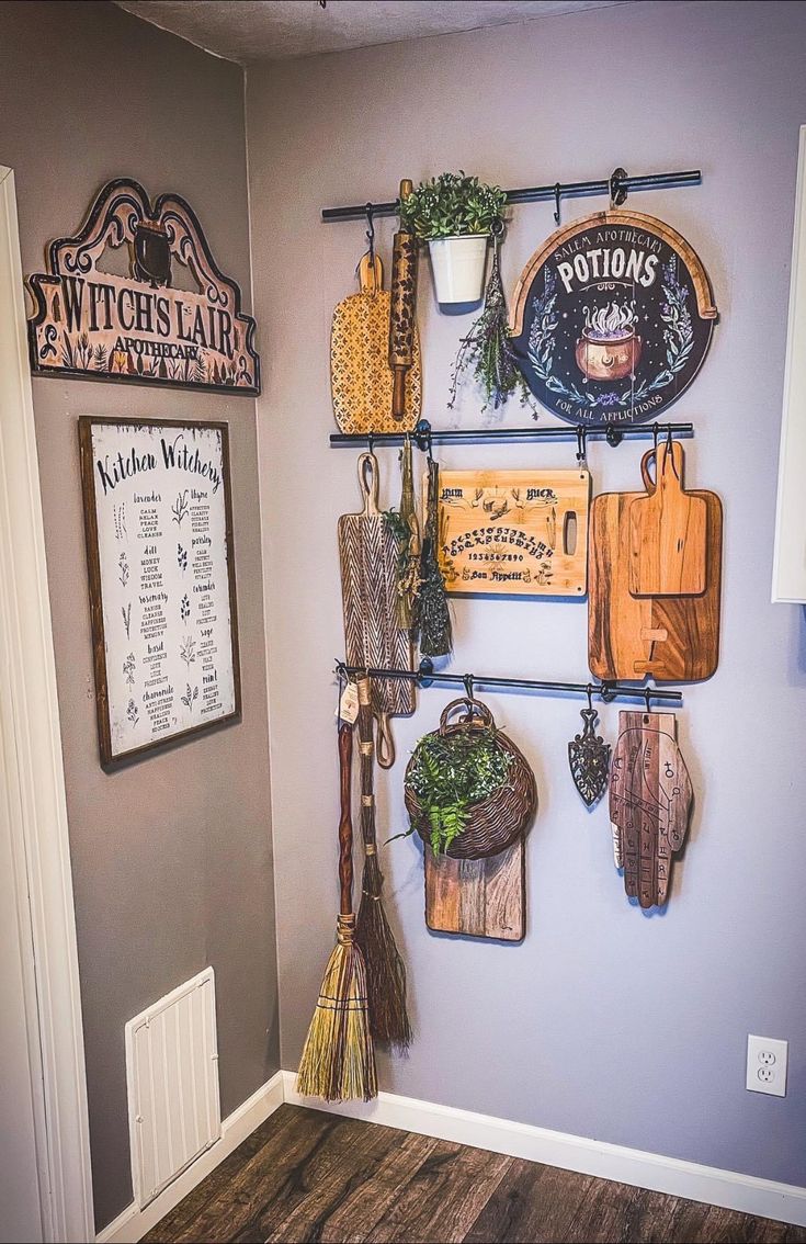 a kitchen with wooden cutting boards hanging on the wall