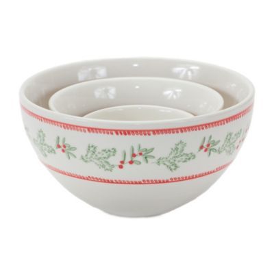 three white bowls with holly designs and red trimmings on the bottom, one bowl has