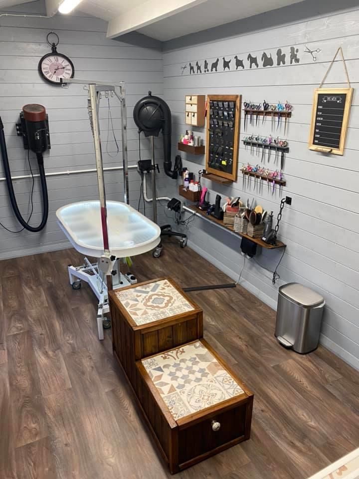 the inside of a barbershop with wooden floors and white walls, two stools on each side