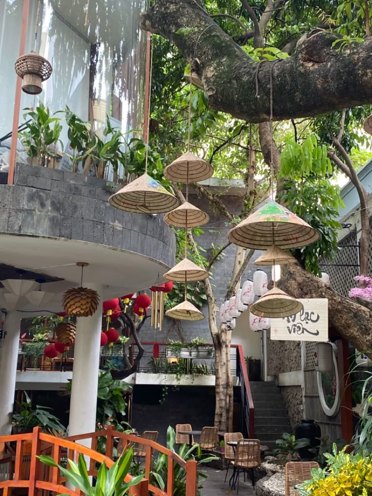 an outdoor cafe with umbrellas hanging from the ceiling