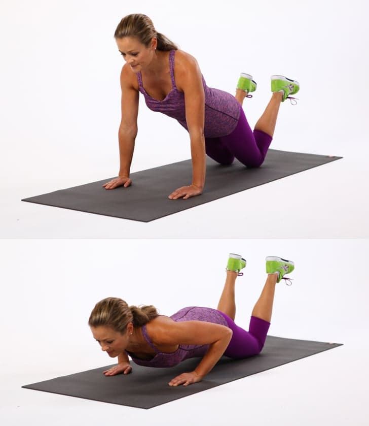 a woman is doing push ups on her stomach and knees with one leg in the air