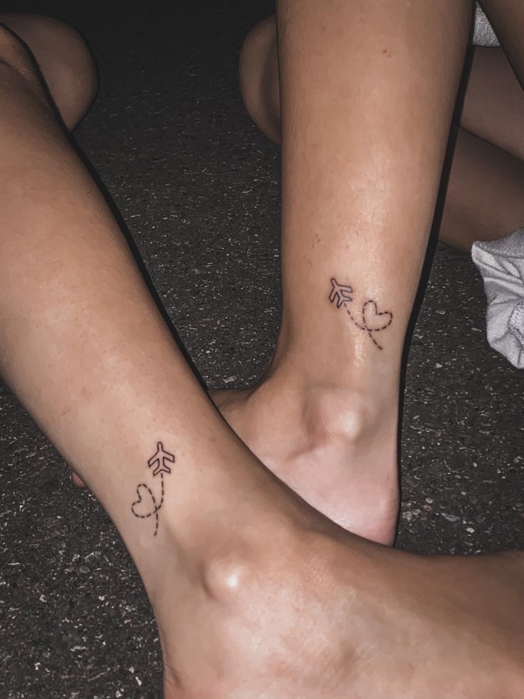 two people with matching tattoos on their legs