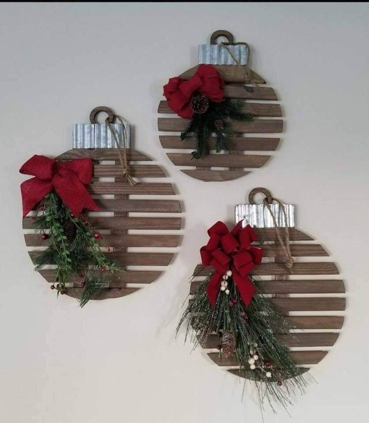 three wooden christmas ornaments hanging on the wall