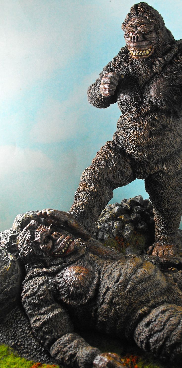 a statue of a bigfoot standing on top of a large alligator's foot