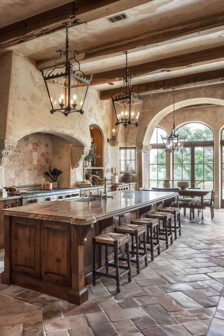 a large kitchen with an island and lots of stools in the middle of it