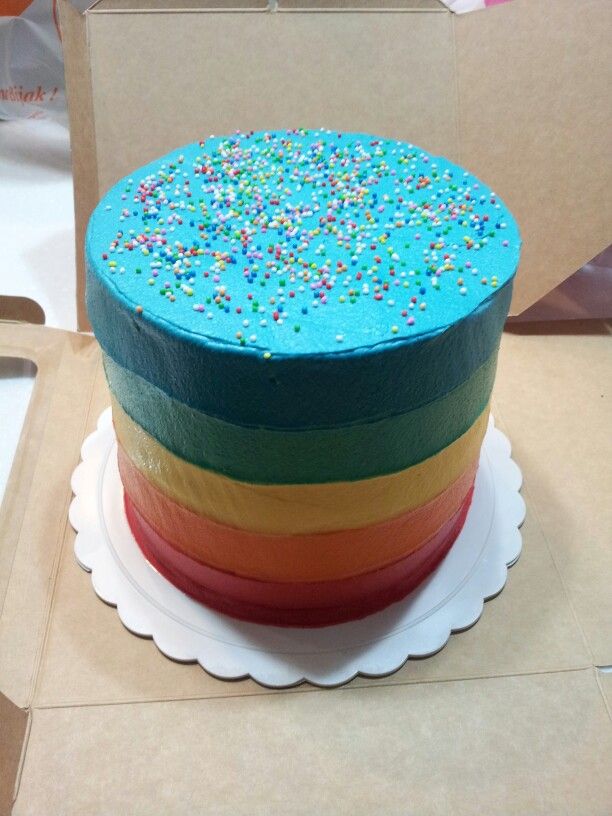 a rainbow cake with sprinkles on top