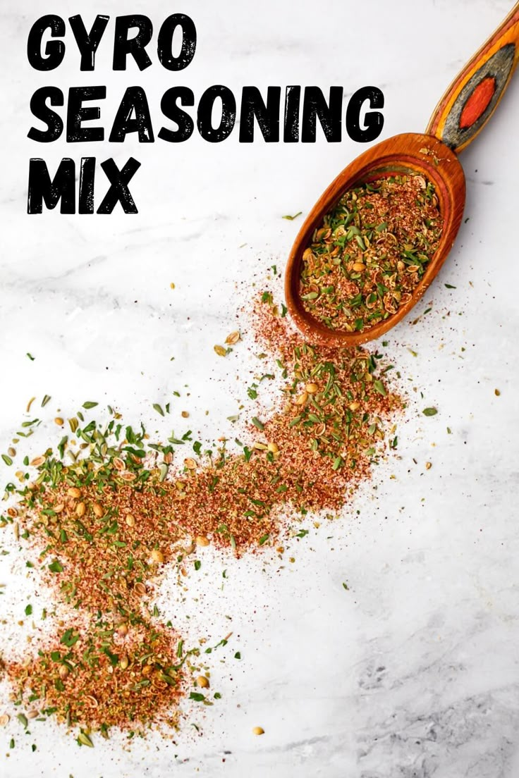 a wooden spoon filled with spices next to a pile of ground flakes on top of a white counter