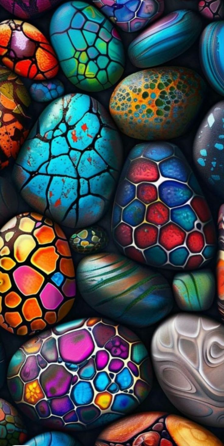 an image of colorful rocks with different colors and shapes on them, all in the same pattern