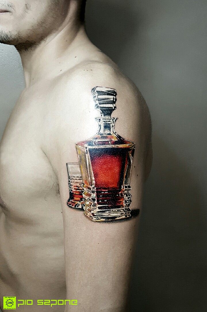 a man with a tattoo on his arm has a bottle and two glasses in it