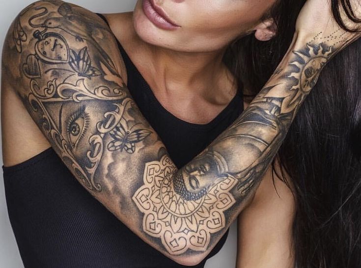 a woman with tattoos on her arms and arm is looking at the camera while holding her hair