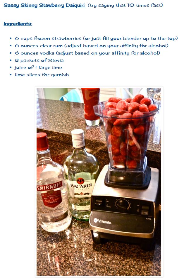 a blender filled with strawberries next to bottles of gin