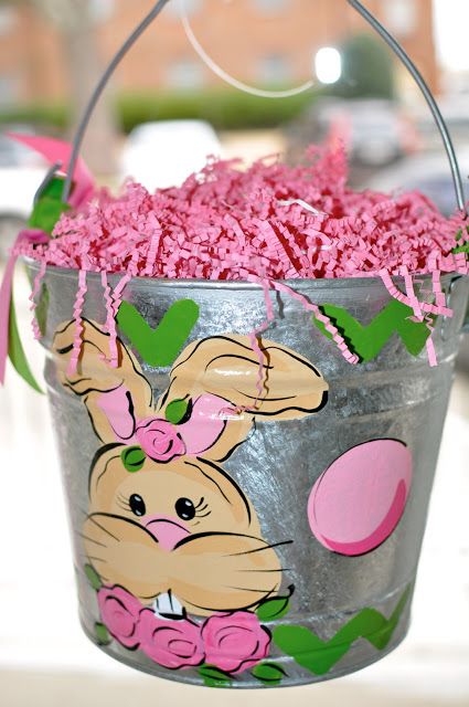 a metal bucket filled with pink candy and sprinkles