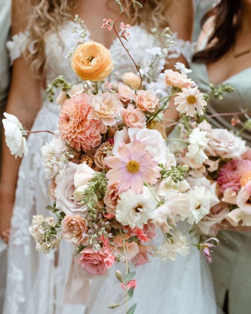 a woman holding a bouquet of flowers in her hand with the caption, i am not sure what this is