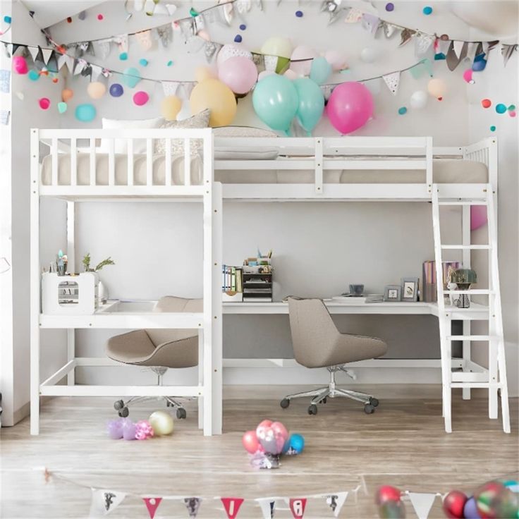 there is a loft bed with a desk underneath it and balloons all over the room