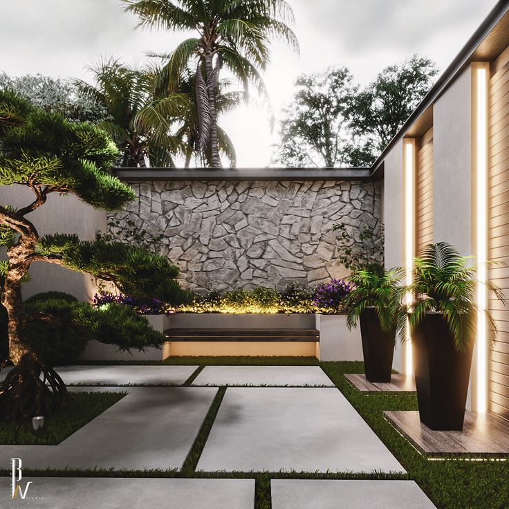 an outdoor courtyard with grass and plants on the ground, next to a stone wall