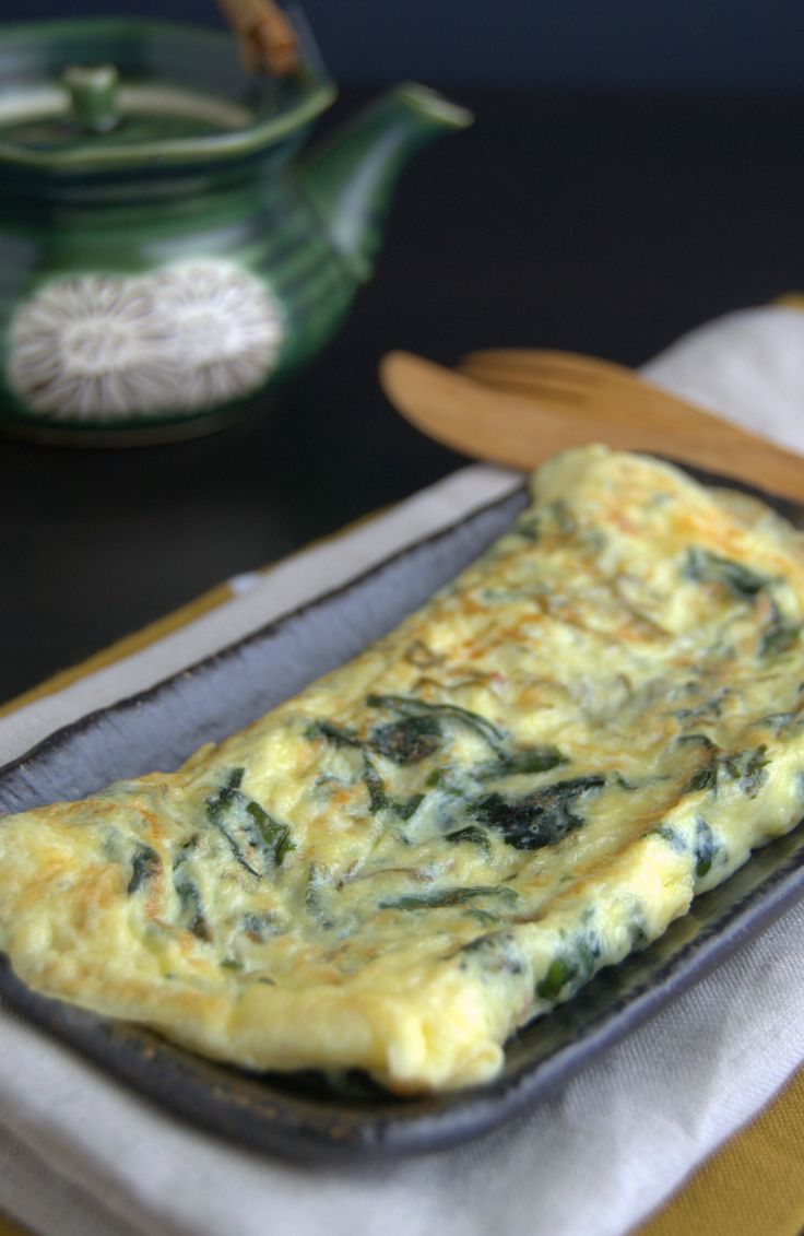 an omelet with spinach and cheese in a baking pan on a table