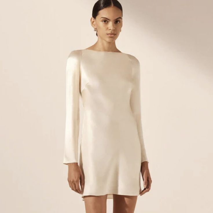 Shona Jo Long Sleeve Backless Mini Dress In Cream In A Lenzing Ecovero With Luxurious Satin Finish. Nwt From Bridal Collection Silk Touch Fabric Luxurious Sheen Round Neckline With Tie Closure Long Slim Sleeves Low Open Back With Cowl Detail Mini Length, Cut On The Bias Medium Weight, Non-Stretchy Woven 58% Lenzing Ecovero 42% Viscose Lined Designed In Australia Available Online At Full Price Long Sleeve Rehearsal Dress, Winter Engagement Party Dress, Winter Wedding Rehearsal Outfit, White Long Sleeve Silk Mini Dress, Fall Bridal Shower Dress, Rehersal Dinner Dress, White Winter Dress, Satin Short Dress, Long Sleeve White Dress