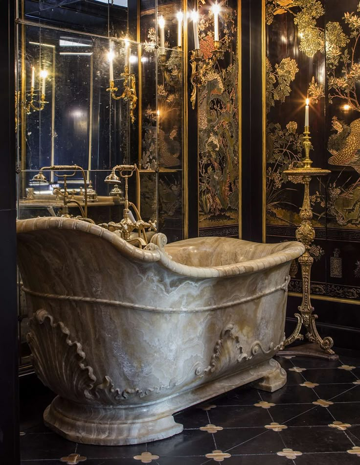 an ornate bathtub in the middle of a room with chandeliers and mirrors