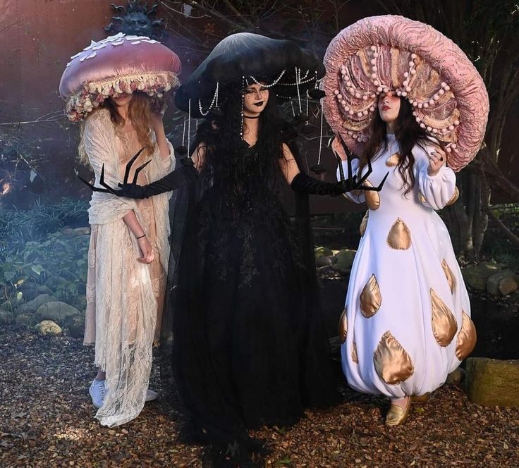 three women dressed in costumes standing next to each other