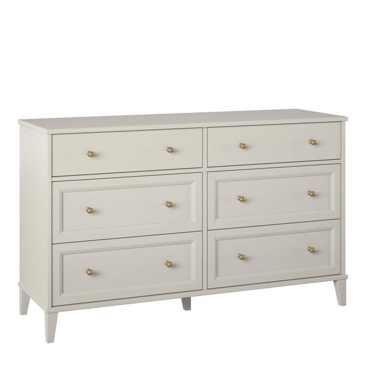 a white dresser with gold handles and drawers