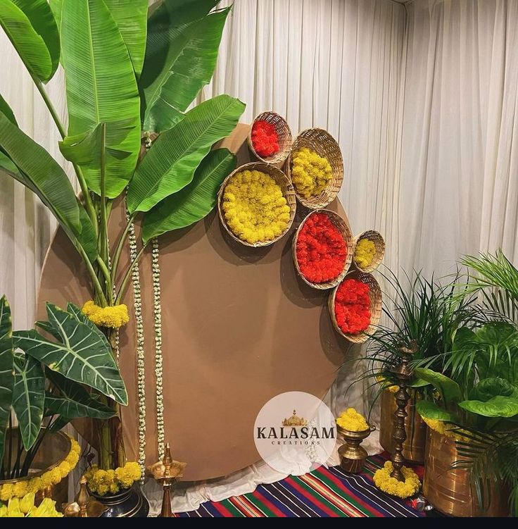 there are many different plants in baskets on the table and one is decorated with flowers