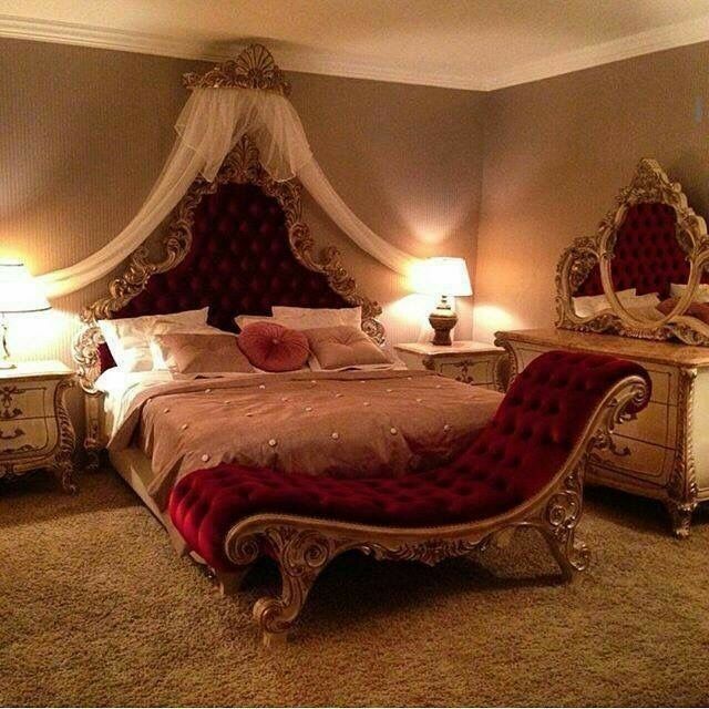 a bedroom with a bed, dressers and two lamps on either side of the bed