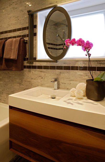 a bathroom with a sink, mirror and bathtub in it's center area