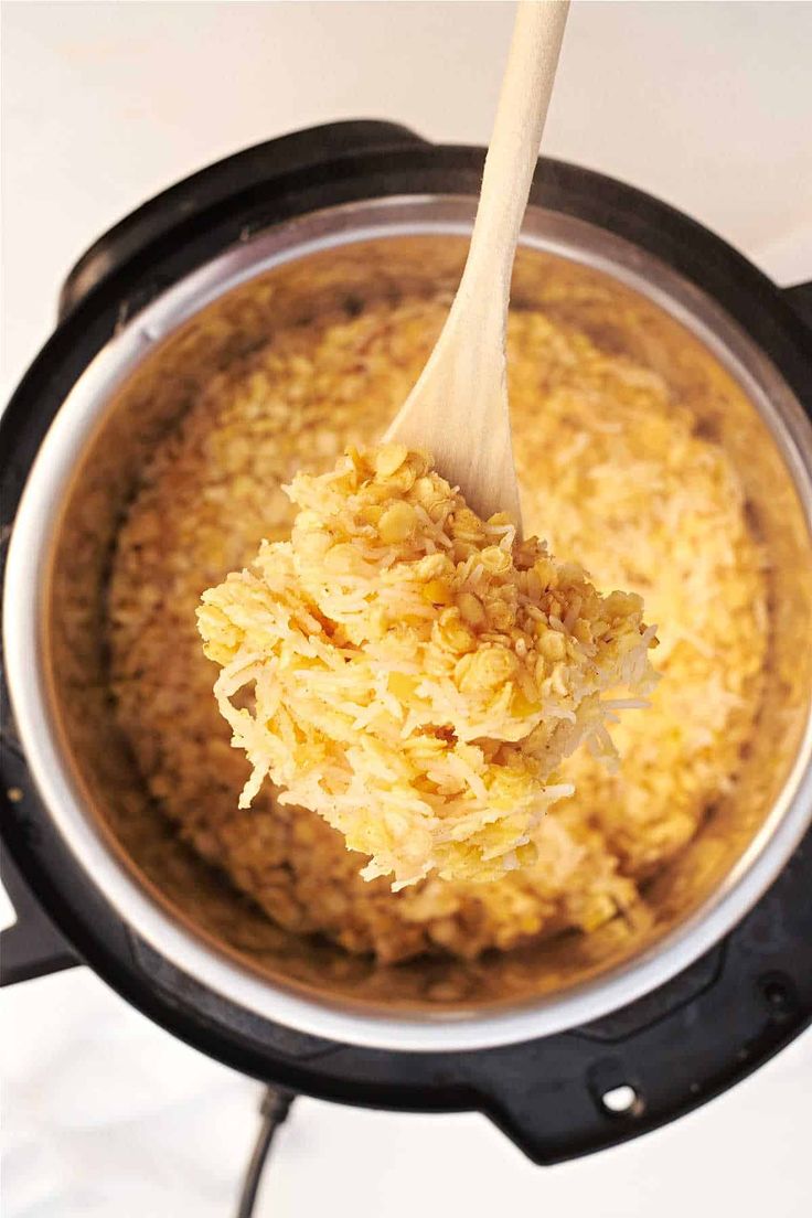 a wooden spoon in an instant pot filled with food