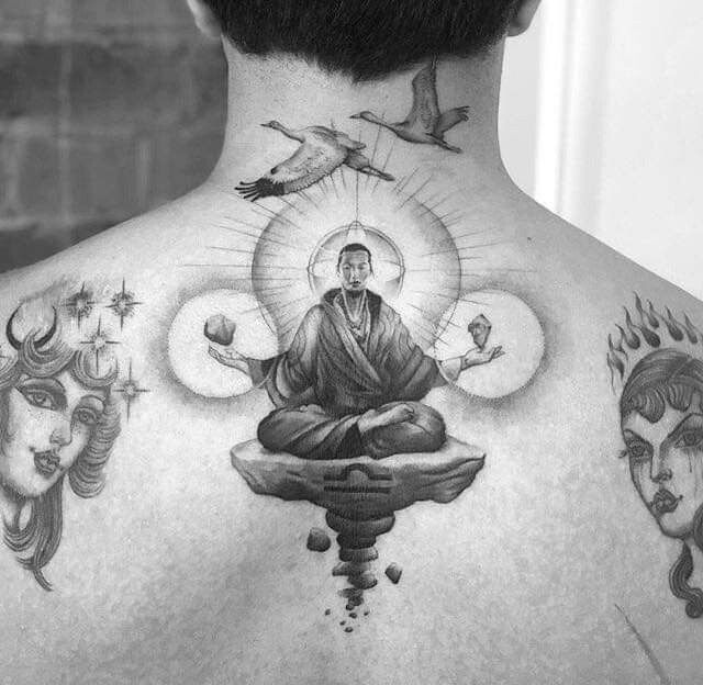 the back of a man's neck with tattoos on it and an image of buddha