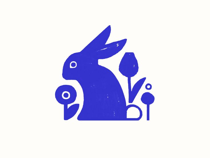 a blue rabbit sitting next to some flowers