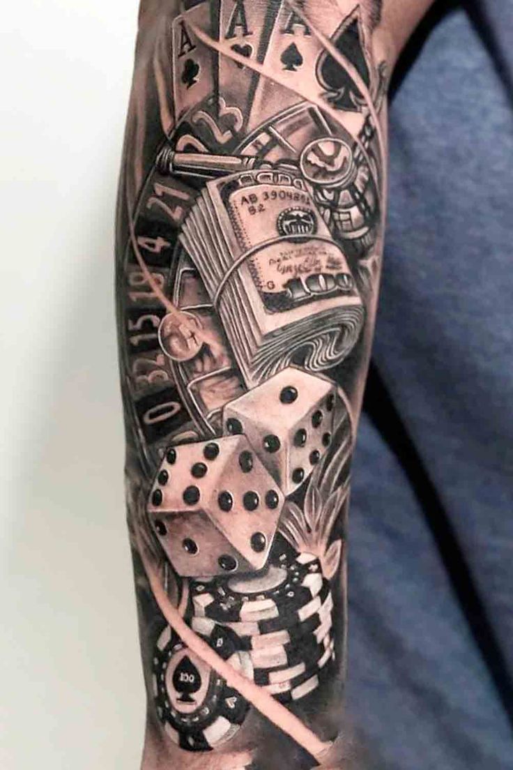 a man with a black and white tattoo on his arm holding a dice, playing cards and