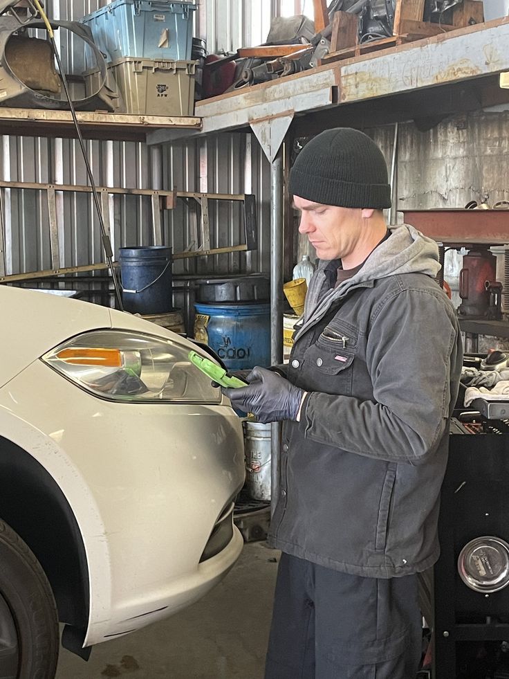 a man working on a car in a garage