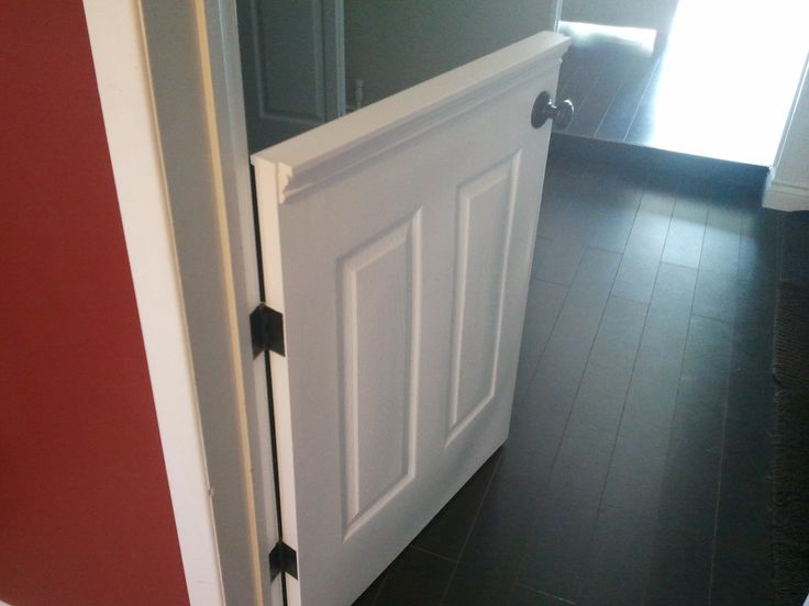 a white door is open on a black floor