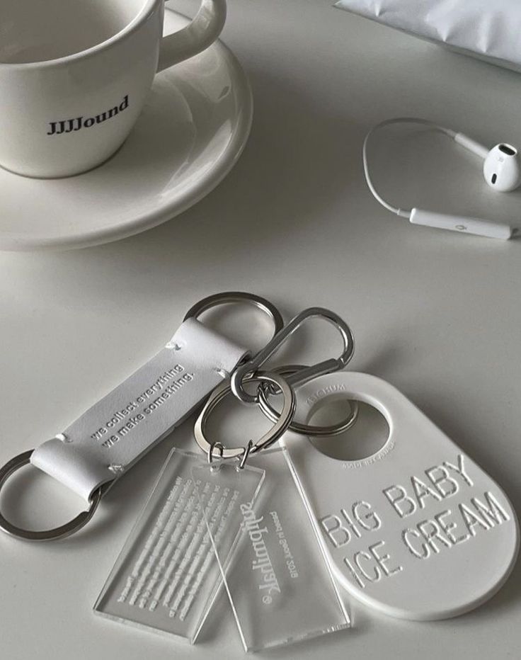 a cup, saucer and pair of scissors are sitting on a white table top