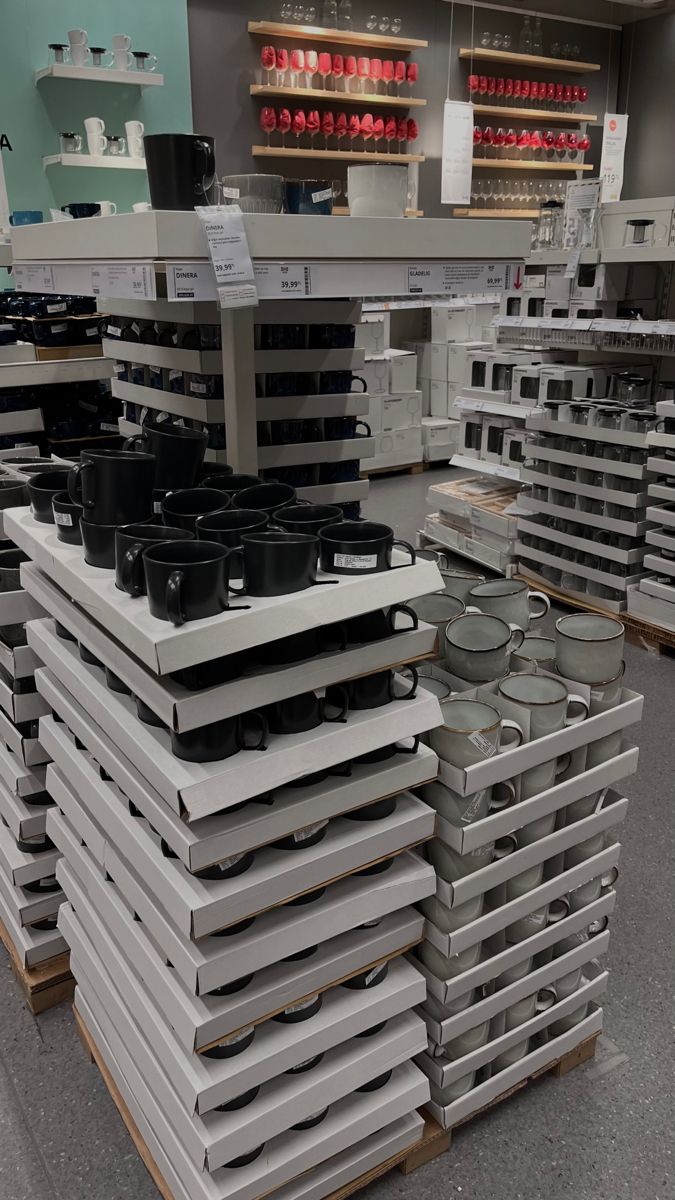 stacks of pots and pans on display in a store