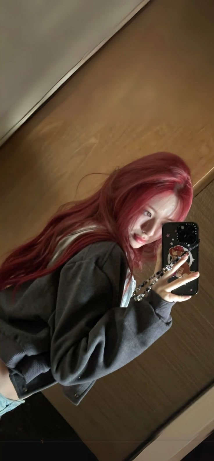 a woman with red hair taking a selfie