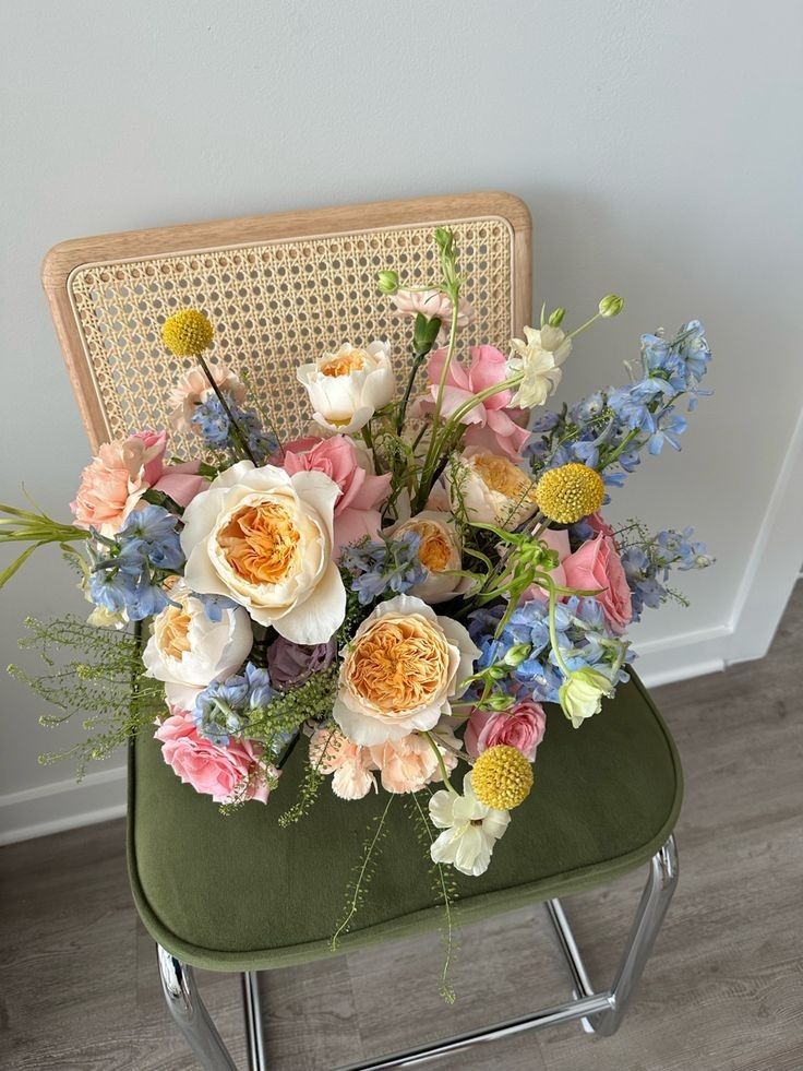 a bouquet of flowers sitting on top of a green chair