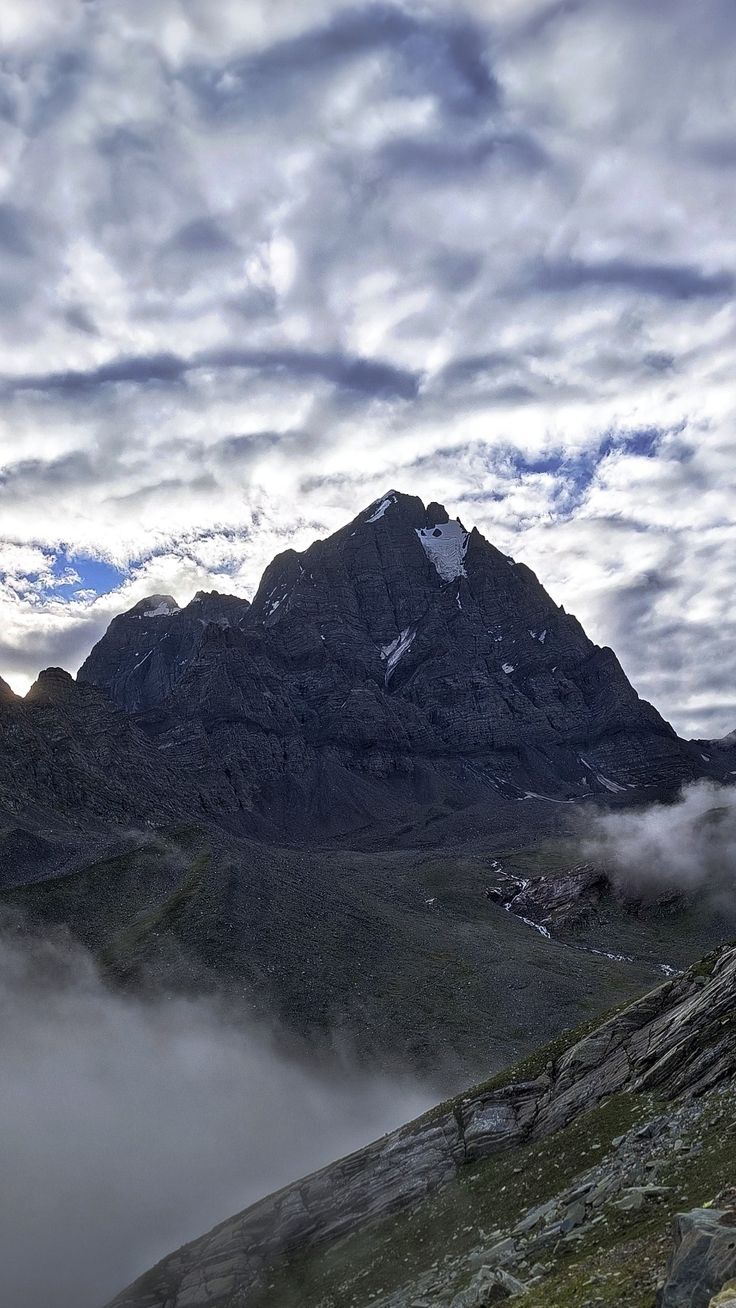 the mountains are covered in low lying clouds