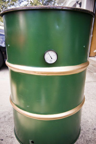 a large green barrel with a clock on it