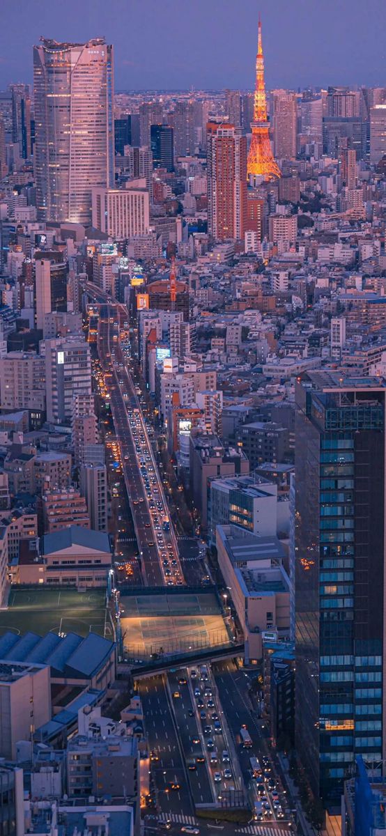 an aerial view of a city at night with the eiffel tower in the distance