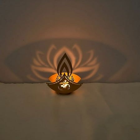 a lamp that is on top of a white surface with an orange light in the middle