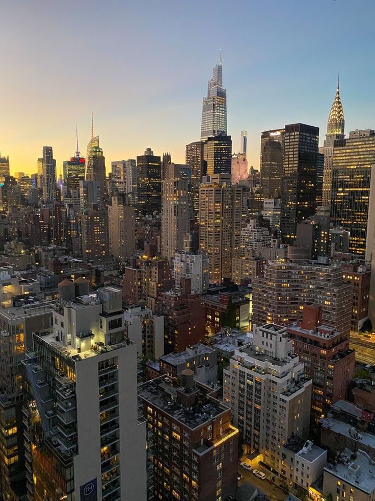 an aerial view of the city skyline at night, with skyscrapers in the background