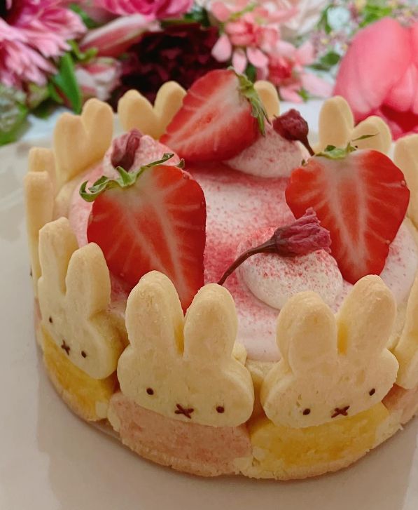 a cake with strawberries and bunny ears on it